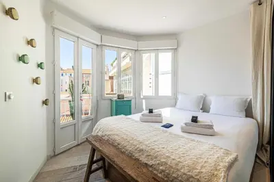 a bedroom with a large white bed with a window at Superb flat - 2BR- 4 P - Cannes in Cannes