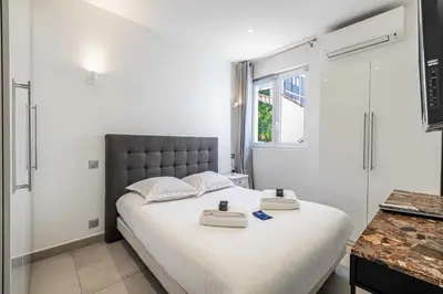 a bedroom with a bed with two towels on it at Charming flat - AC - 2BR - 6P - Cannes in Cannes