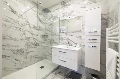 a bathroom with a sink and a glass shower at Charming flat - AC - 2BR - 6P - Cannes in Cannes