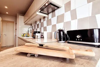 a kitchen with a cutting board on a counter at Beautiful 2-bedroom apt - sea and city view in Cannes