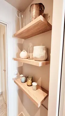 a kitchen with wooden shelves with bowls and jars at Beautiful 2-bedroom apt - sea and city view in Cannes