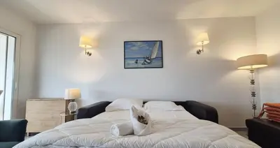 a bedroom with a white bed with two pillows at Beautiful 2-bedroom apt - sea and city view in Cannes