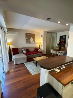 a living room with a couch and a table at Les alizés Cannes in Cannes