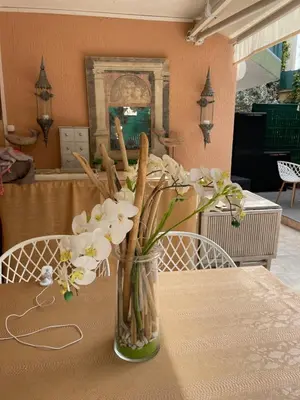 a vase of flowers sitting on a table at Les alizés Cannes in Cannes