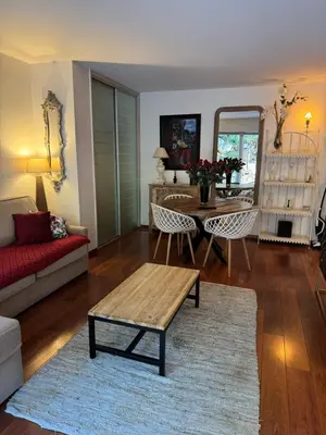 a living room with a table and a couch at Les alizés Cannes in Cannes
