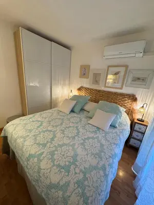 a bedroom with a large bed with blue pillows at Les alizés Cannes in Cannes