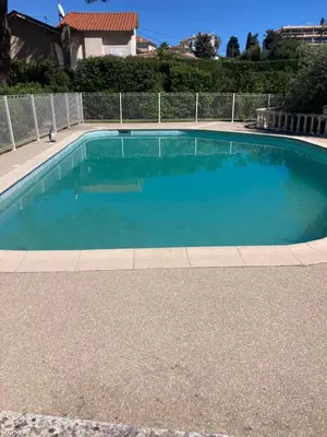 a large swimming pool with blue water at Les alizés Cannes in Cannes