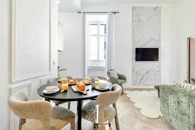 a living room with a black table and chairs at Les Lucioles 4- Luxury 1 Bedroom Apartment in Cannes