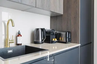 a kitchen with a sink and a coffee maker at Les Lucioles 4- Luxury 1 Bedroom Apartment in Cannes
