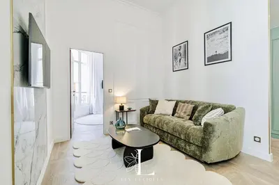 a living room with a couch and a table at Les Lucioles 4- Luxury 1 Bedroom Apartment in Cannes