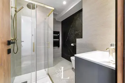 a bathroom with a shower with a sink and a toilet at Les Lucioles 4- Luxury 1 Bedroom Apartment in Cannes