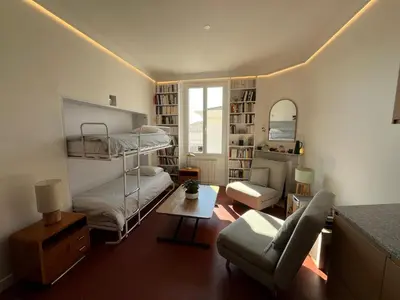 a living room with a bunk bed and a couch at Elégant appartement 2 pièces centre Cannes Croisette plages in Cannes