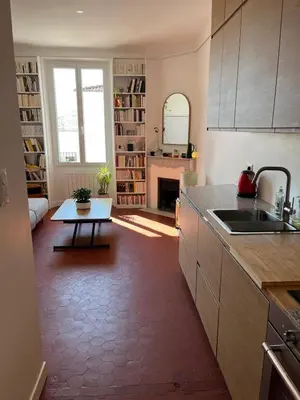 a kitchen with a sink and a table in a room at Elégant appartement 2 pièces centre Cannes Croisette plages in Cannes
