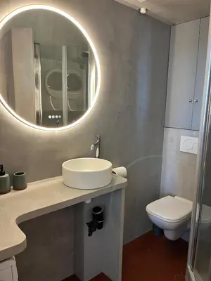 a bathroom with a sink and a toilet and a mirror at Elégant appartement 2 pièces centre Cannes Croisette plages in Cannes