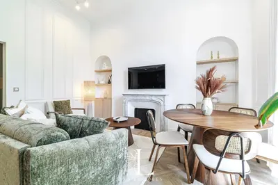 a living room with a couch and a table at Les Lucioles 5- Luxury 2-Bedroom Apartment in Cannes