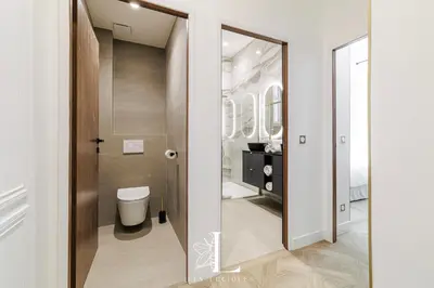 a bathroom with a toilet and a mirror at Les Lucioles 5- Luxury 2-Bedroom Apartment in Cannes