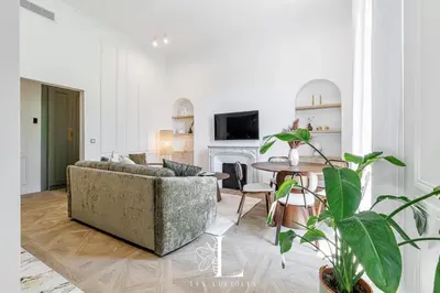 a living room with a couch and a table at Les Lucioles 5- Luxury 2-Bedroom Apartment in Cannes