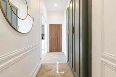 a hallway with white walls and a mirror at Les Lucioles 5- Luxury 2-Bedroom Apartment in Cannes