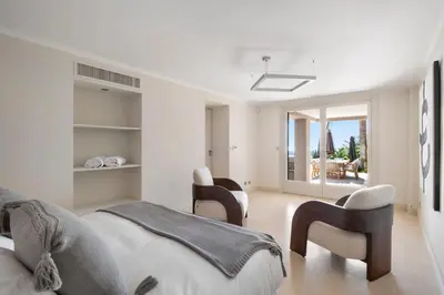 a bedroom with two beds and two chairs at REF 2138 - Cannes - Villa sea view in Cannes