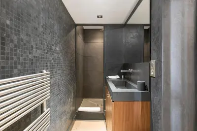 a bathroom with a sink and black tiles at REF 2138 - Cannes - Villa sea view in Cannes