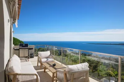 a balcony with chairs and a view of the ocean at REF 2138 - Cannes - Villa sea view in Cannes