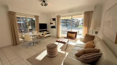 a living room with a couch and a table at Avenue de Madrid 19 - Croisette Madrid in Cannes