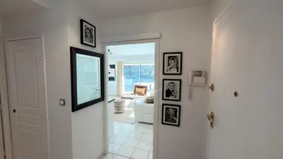 a room with a hallway with pictures on the wall at Avenue de Madrid 19 - Croisette Madrid in Cannes