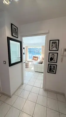 a living room with a doorway with pictures on the wall at Avenue de Madrid 19 - Croisette Madrid in Cannes