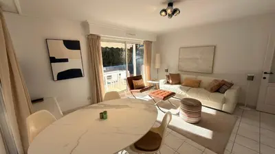 a living room with a table and a couch at Avenue de Madrid 19 - Croisette Madrid in Cannes