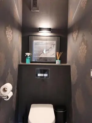 a bathroom with a toilet and a tv on the wall at Avenue de Madrid 19 - Croisette Madrid in Cannes