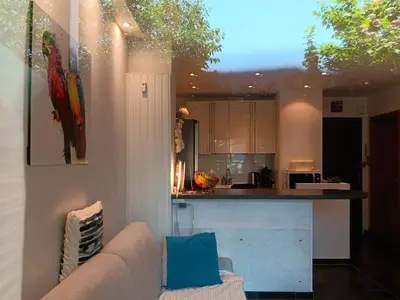a kitchen with a couch and a counter in a room at L'Atlantide in Cannes