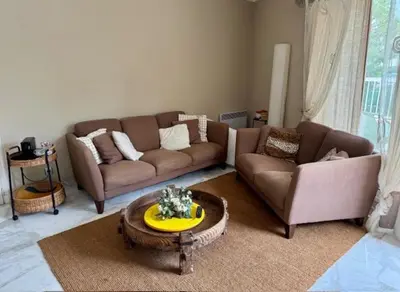 a living room with a couch and a coffee table at The Noailles - Lovely flat with swimming pool five minutes from the beach in Cannes