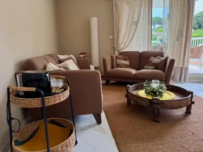 a living room with a couch and a table at The Noailles - Lovely flat with swimming pool five minutes from the beach in Cannes