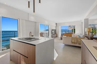 a kitchen and living room with a view of the ocean at REF 2005 Cannes Center Appartment for rent in Cannes