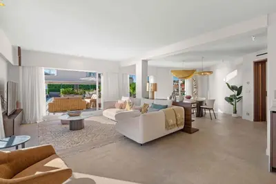 a living room with a white couch and a table at REF 2005 Cannes Center Appartment for rent in Cannes