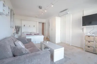 a living room with a couch and a table at Wdf studio in the heart of Cannes! in Cannes
