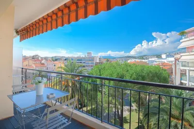 a balcony with a table and a view of a city at Wdf studio in the heart of Cannes! in Cannes