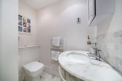 a white bathroom with a sink and a toilet at Truly amazing 3 bedrooms Cannes center!! in Cannes