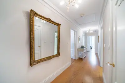 a hallway with a mirror on a wall at Truly amazing 3 bedrooms Cannes center!! in Cannes