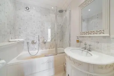 a white bathroom with a sink and a shower at Truly amazing 3 bedrooms Cannes center!! in Cannes