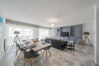 a living room with a table and a couch at Wdf 2 bedrooms heart of Cannes!! in Cannes