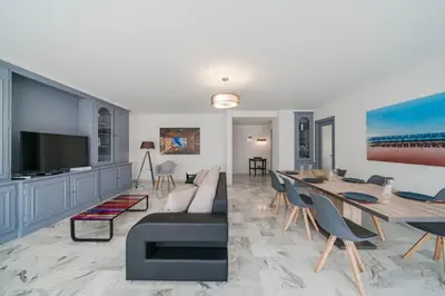 a living room with a couch and a dining room at Wdf 2 bedrooms heart of Cannes!! in Cannes