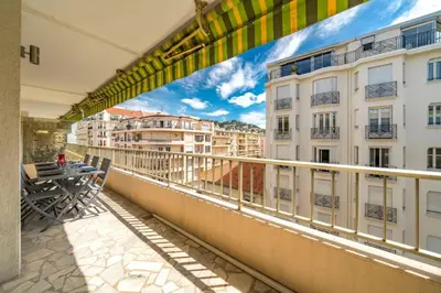 a balcony with a table and a view of buildings at Wdf 2 bedrooms heart of Cannes!! in Cannes