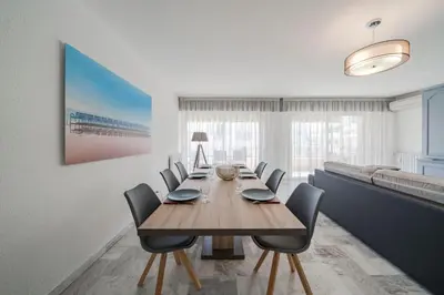 a dining room with a wooden table and chairs at Wdf 2 bedrooms heart of Cannes!! in Cannes