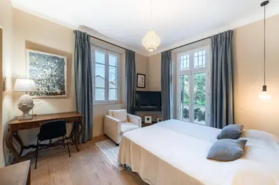 a bedroom with a bed and a desk and a chair at Contemporary house in the center of Cannes with a pool and relaxation area in Cannes