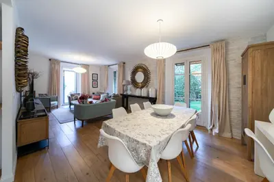 a dining room and living room with a table and chairs at Contemporary house in the center of Cannes with a pool and relaxation area in Cannes
