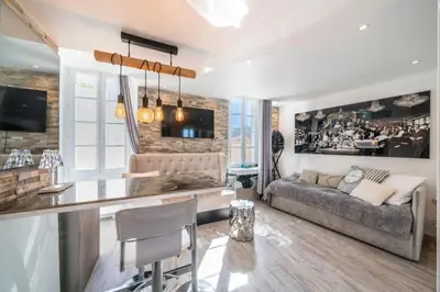 a living room with a couch and a table at Beautiful studio rue d'Antibes in Cannes
