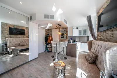 a living room with a couch and a kitchen at Beautiful studio rue d'Antibes in Cannes