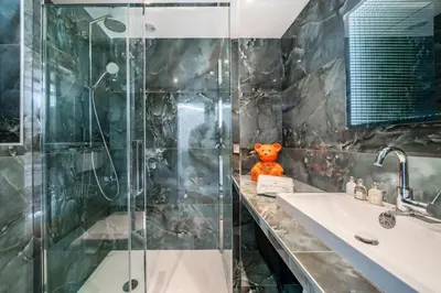 a bathroom with a glass shower and a sink at Beautiful studio rue d'Antibes in Cannes