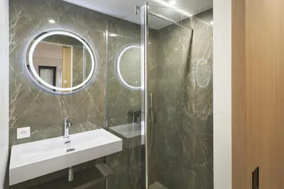 a bathroom with a sink and a mirror at Wdf 2 bedroom heart of Cannes in Cannes